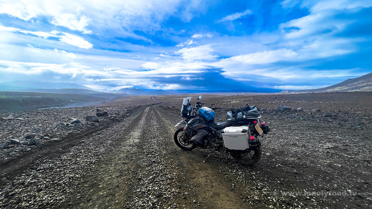 A picture of a KTM 890 Adventure motorcycle parked on a remote gravel road in Iceland