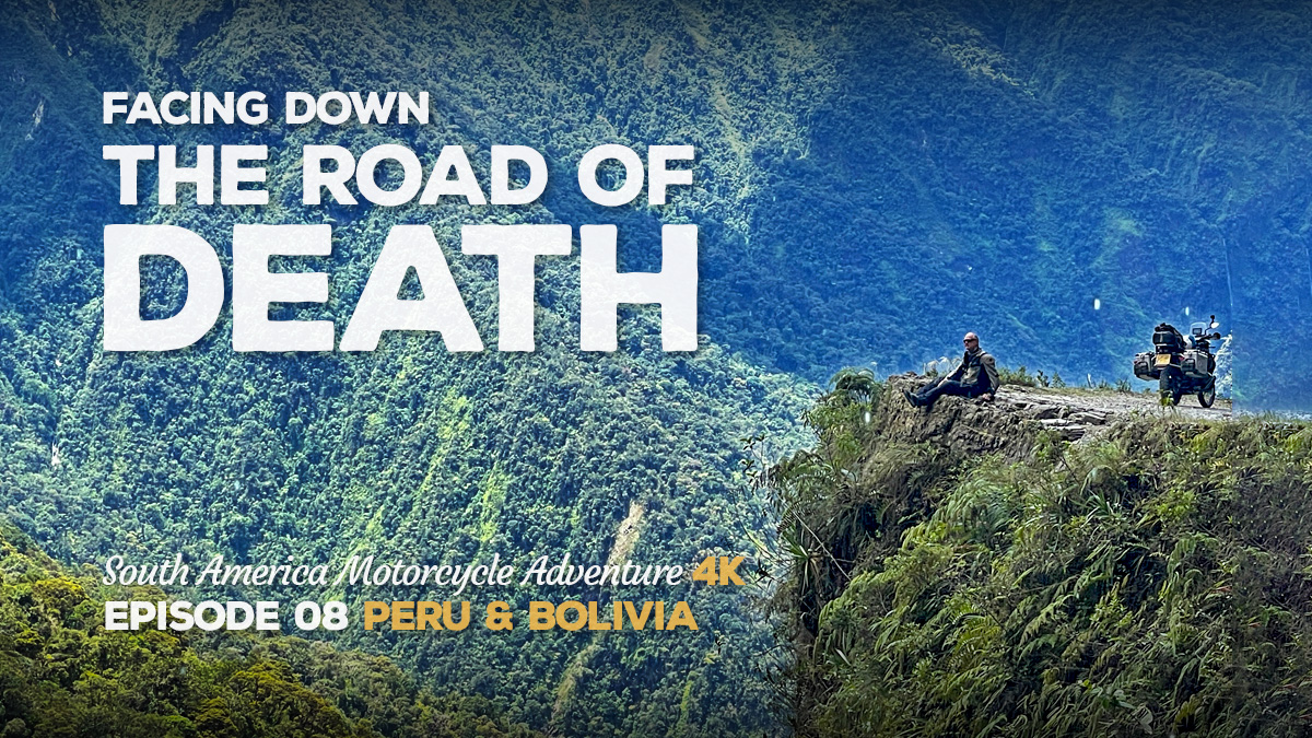 A long distance photo of Benjamin Craig sitting on a cliff on the Bolivian Road of Death