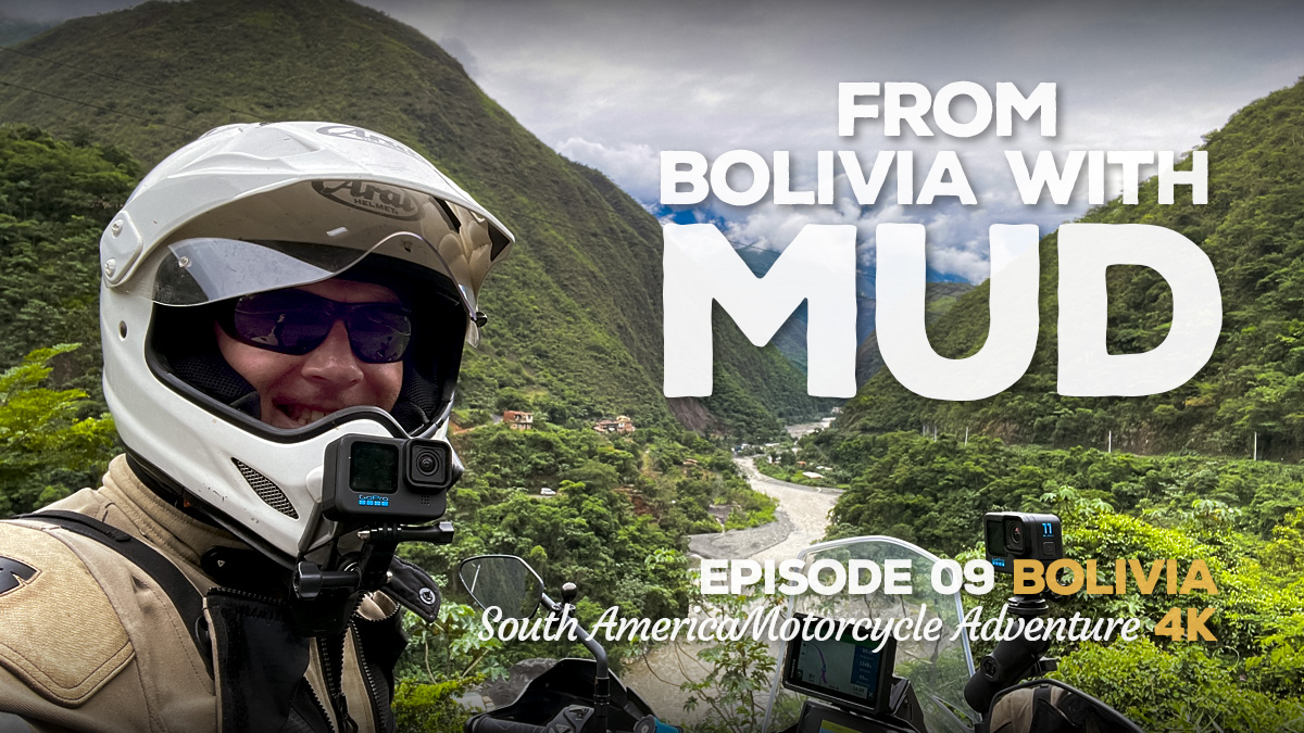 A photo of a man in a motorcycle helmet against a mountain valley backdrop in Bolivia