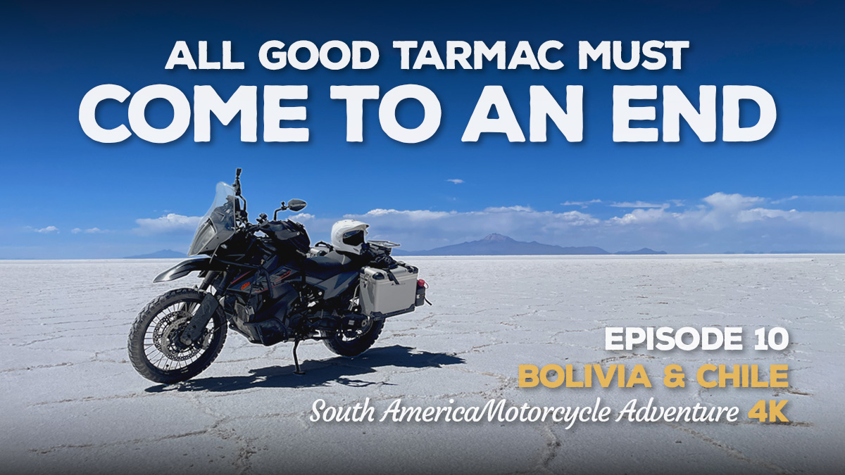 A photo of a KTM 890 Adventure motorcycle parked on the Uyuni Salt Flats in Bolivia in bright sunshine